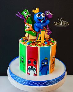 a birthday cake decorated with monsters and letters