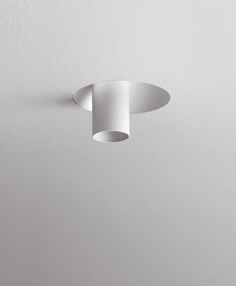 a white ceiling light hanging from the ceiling in a room with no one around it