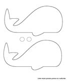 two whale cut outs sitting next to each other on top of a white sheet paper