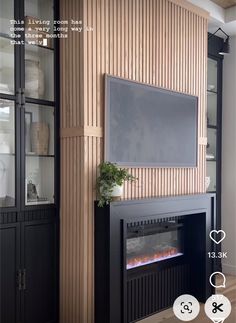 a living room with a fireplace and entertainment center in front of a flat screen tv