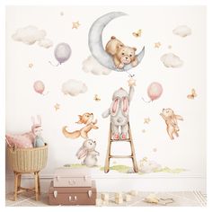 a child's room with a teddy bear on the moon wall sticker and other toys