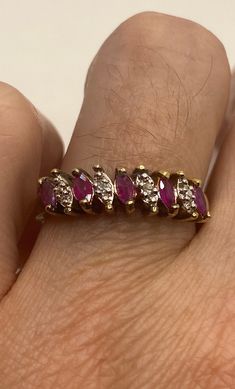 This is a vintage red ruby with tiny diamonds ring set in gold 925 sterling silver set in a lovely pattern. Size 8 this can be sized to your specification, please message us to discuss sizing your ring or engraving options. Sizing costs $20, engraving $4 per letter. All of our jewelry is hand polished and shipped to you in a stylish gift box. We are happy to gift wrap for you. It is important to us that each customer be thrilled with their purchase. We are grateful for thousands of positive revi Red Marquise Ruby Ring With Prong Setting, Fine Jewelry Red Diamond Ring Stamped 14k, Red Ruby Diamond Ring Hallmarked, Heirloom Red Jewelry With Diamond Accents, Vintage Ruby Ring With Diamond Accents, Red Rings With Diamond Accents For Anniversary, Ruby Rings With Diamond Accents For Gift, Classic Marquise Red Diamond Ring, Red Ruby Ring With Diamond Accents In 14k Gold