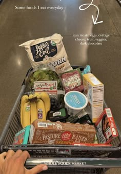 a shopping cart filled with food and snacks