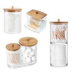 three clear containers with wooden lids and matchesticks on the top one is filled with white cotton swabs