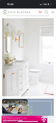 a bathroom with white cabinets and pink accents