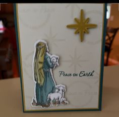 a christmas card with a nativity scene and a star on the top that says peace on earth