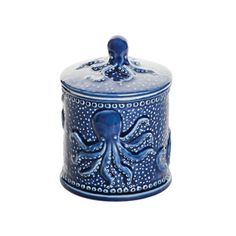 an ornate blue container with an octopus design on the front and bottom, sitting against a white background