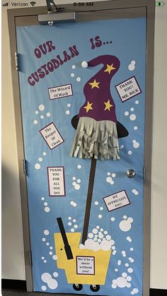 a door decorated to look like a wizard's hat and broom with words on it