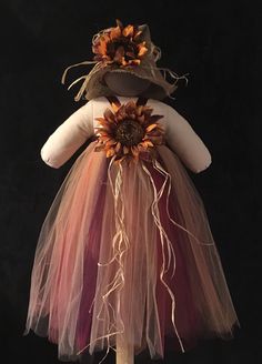 a dress made out of tulle and fabric with sunflowers on the back