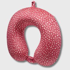 a red and white polka dot print neck pillow