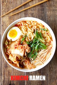 a bowl of ramen with an egg on top and chopsticks next to it