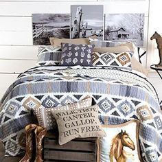 a bed with pillows and pictures on the headboard, along with cowboy themed decor