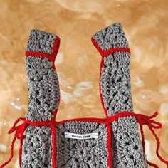 there is a crocheted bag with red ribbon around it