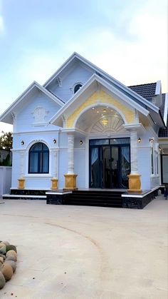 a white house with yellow trim and columns