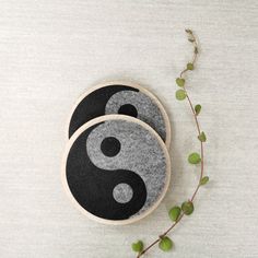 two black and white coasters sitting on top of a table