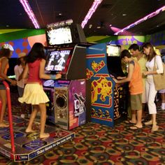 children playing video games in an arcade