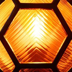 the light is shining brightly in an octagonal glass window with hexagonal pattern on it