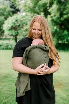 a woman holding a baby in her arms