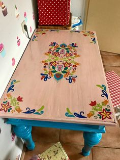 a wooden table with colorful designs on it