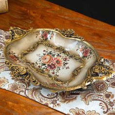 an ornately decorated bowl sits on a table