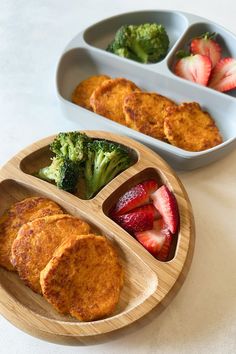 two trays filled with different types of food on top of a white countertop