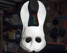 a white mask that has been made to look like a rabbit's head with two eyes