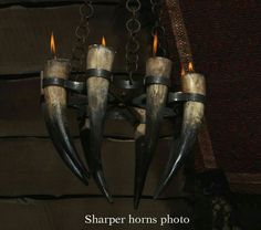 an old chandelier with horns hanging from it's sides and candles in the middle