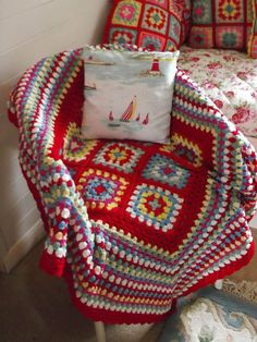 a crocheted chair with a pillow on it