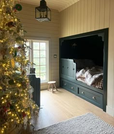 a bedroom with a christmas tree in the corner