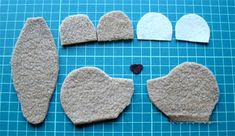 several pieces of felt are laid out on a cutting board to make heart - shaped shapes