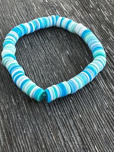 Embrace the calming essence of the ocean with the Ocean Breeze Clay Bead Bracelet! Handmade with care, this bracelet features a stunning array of cool blue, teal, and white flat clay beads, creating a serene and coastal-inspired accessory. Perfect for beach days, casual outings, or as a thoughtful gift, this lightweight bracelet is designed to bring you that refreshing ocean vibe wherever you go. 🌟 Product Details:     Handmade Item: Carefully crafted with love and attention to detail.     Materials: Flat clay beads in calming ocean tones, strung on a durable elastic cord.     Size: Approximately 6 inches - stretchy and comfortable for all-day wear.     Production Time: Made to order in 2-3 business days.     Ships From: California, USA. ✨ Why You'll Love It:     Coastal Color Palette: Sh Flat Clay Beads, Coastal Color Palette, Clay Bead Bracelet, Coastal Colors, Coastal Vibes, White Flat, Photo Proof, Ocean Vibes, Clay Bead