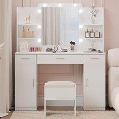 a white dressing table with lights on it