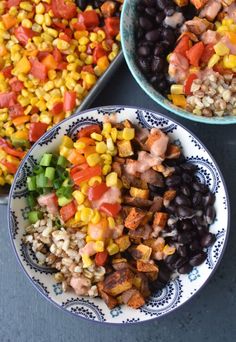 two bowls filled with black beans, corn and other vegetables on top of a table