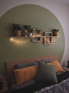 a bed room with a neatly made bed and two shelves on the wall above it