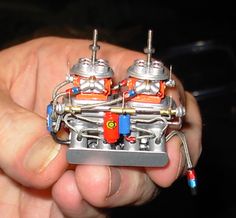 a person is holding a small toy engine