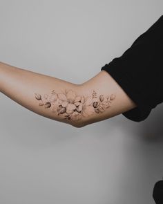 a woman's arm with flowers on it