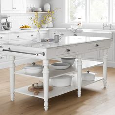 a white kitchen with an island in the middle