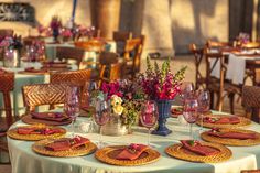 a table set with place settings and flowers