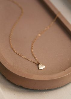 Small heart charm on a delicate 14kt Gold Fill necklace. Cheap Delicate Chain Pendant Jewelry, Cheap Delicate Chain Necklace For Gift, Cheap Pendant Chain Necklace For Valentine's Day, Cheap Minimalist Necklaces For Anniversary, Cheap Nickel-free Dainty Jewelry, Cheap Delicate Everyday Jewelry, Cheap Stainless Steel Dainty Jewelry, Cheap Romantic Valentine's Day Necklaces, Cheap Heart Pendant Necklace With Short Chain