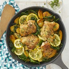 a pan filled with chicken and vegetables on top of a table