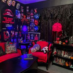 a living room filled with red couches and halloween decorations