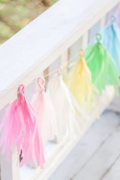 colorful streamers hanging from the side of a white railing