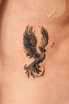 a black and white bird tattoo on the chest