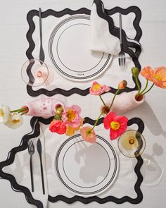 a place setting with flowers and wine glasses