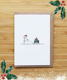 a card with a drawing of a person pulling a sleigh and presents on it