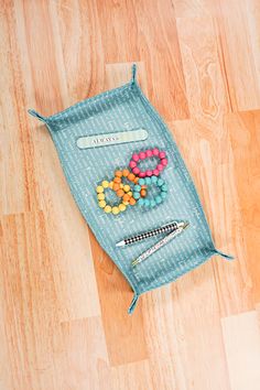 a bag filled with lots of candy on top of a wooden floor next to a pen