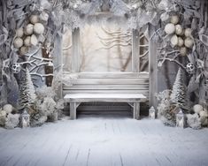 a white bench sitting in front of a snow covered wall with christmas decorations on it