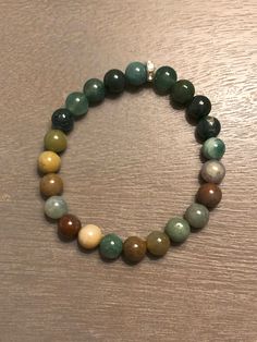 Embrace the beauty of the natural world with our Indian & Green Moss Bead Bracelet, a tribute to the elegance of the natural gems. Crafted with care and attention to detail, whether you're a fan of minimalist chic or you prefer bold, statement pieces, our nature-inspired bracelets offer an array of choices. Wearing this bracelet is like carrying a piece of nature's serenity with you, allowing you to express your love for the world around us and your unique style simultaneously. Perfect for both Casual Agate Bead Jewelry, Casual Agate Beaded Bracelets With Round Beads, Casual Agate Beaded Jewelry, Casual Agate Round Beads Jewelry, Agate Stretch Bracelet With 8mm Beads For Healing, Casual Round Agate Beaded Bracelets, Casual Agate Gemstone Beaded Bracelets, Casual Agate Jewelry With Natural Stones, Casual Agate Beaded Bracelets With Gemstone Beads