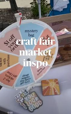 a colorful wheel with words on it sitting next to other items that are for sale