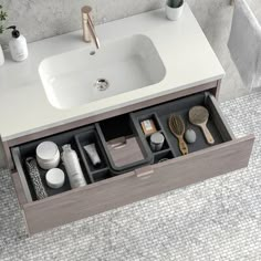 a bathroom sink sitting under a mirror next to a counter top with various items in it